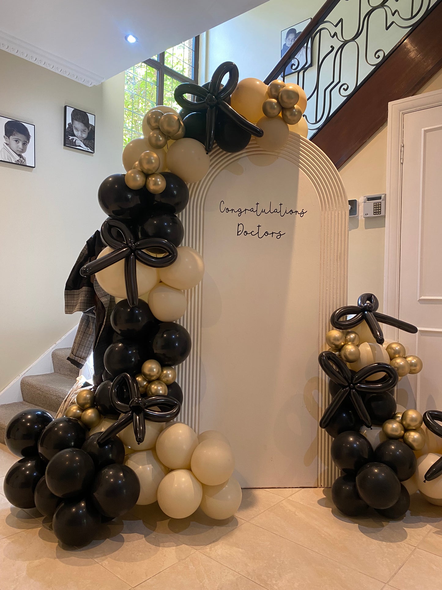 Beautiful black & sand white arch with bows