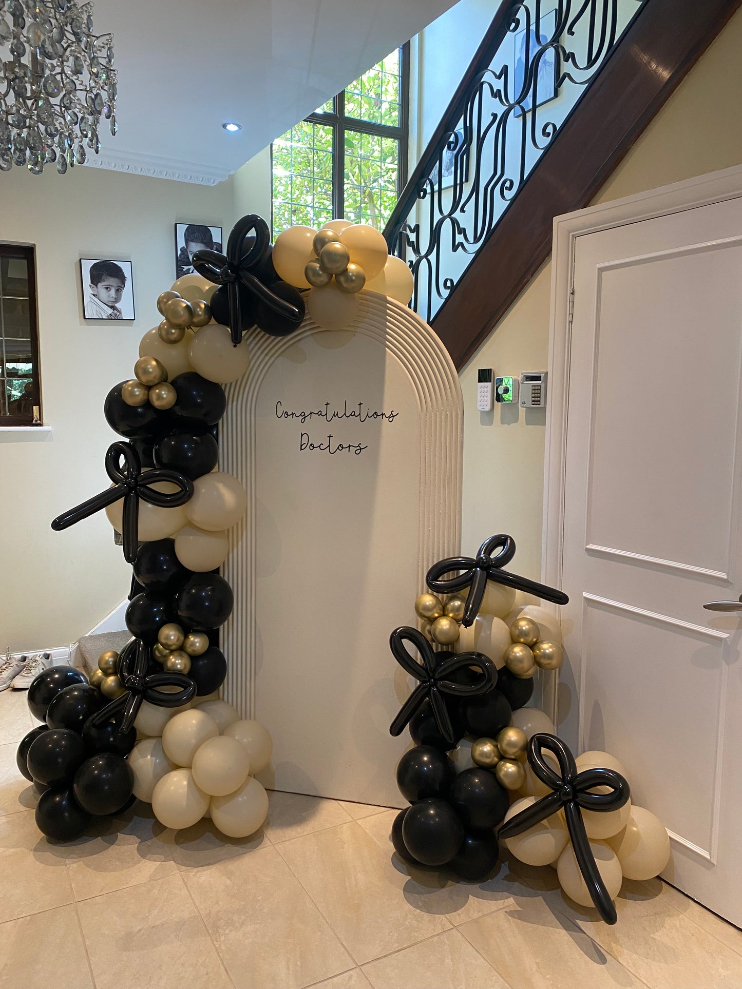 Beautiful black & sand white arch with bows