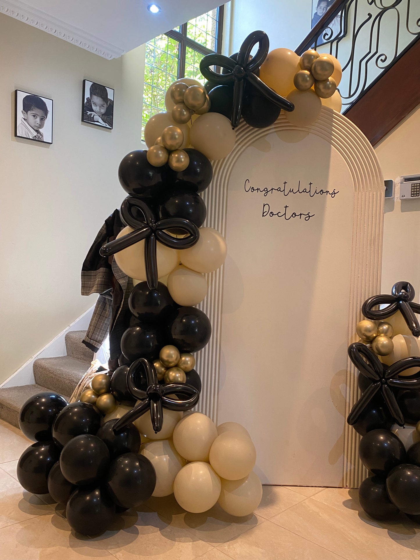 Beautiful black & sand white arch with bows