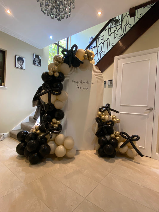 Beautiful black & sand white arch with bows